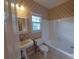 This is a standard bathroom with a sink, toilet and tub with shower at 1272 Saxony Se Dr, Conyers, GA 30013