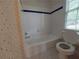 Cozy bathroom featuring a bathtub and toilet with star-themed wallpaper at 1272 Saxony Se Dr, Conyers, GA 30013