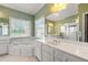 Bright bathroom featuring dual sinks, soaking tub, and large window at 1272 Saxony Se Dr, Conyers, GA 30013