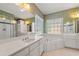 Bright bathroom featuring dual sinks, soaking tub, and shower at 1272 Saxony Se Dr, Conyers, GA 30013