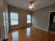 Bedroom with hardwood flooring, a ceiling fan, and natural light from two windows at 1272 Saxony Se Dr, Conyers, GA 30013