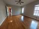 Bedroom has hardwood floors and neutral walls and trim with view to another room at 1272 Saxony Se Dr, Conyers, GA 30013