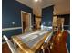 Dining room features hardwood flooring, blue walls, and a view to the kitchen at 1272 Saxony Se Dr, Conyers, GA 30013