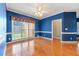 Dining room with hardwood floors, a large window, and blue walls at 1272 Saxony Se Dr, Conyers, GA 30013