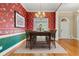 Formal dining room with hardwood floors, modern chandelier, and natural light at 1272 Saxony Se Dr, Conyers, GA 30013