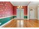 Formal dining room with hardwood floors, floral wallpaper, and elegant chandelier at 1272 Saxony Se Dr, Conyers, GA 30013