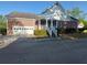 Brick home with attached garage, a covered front porch, and sidewalk at 1272 Saxony Se Dr, Conyers, GA 30013