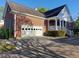 Brick home featuring an attached garage with driveway, and covered front porch at 1272 Saxony Se Dr, Conyers, GA 30013