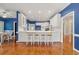 Bright, open kitchen boasts white cabinetry, breakfast bar with seating and hardwood floors at 1272 Saxony Se Dr, Conyers, GA 30013