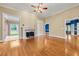 Spacious living room featuring hardwood floors, a fireplace, and large openings to other rooms at 1272 Saxony Se Dr, Conyers, GA 30013