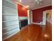Inviting living room featuring a brick fireplace, built-in bookshelves, and hardwood floors at 1272 Saxony Se Dr, Conyers, GA 30013