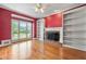 Bright living room with hardwood floors, a fireplace, built-in bookshelves, and natural light at 1272 Saxony Se Dr, Conyers, GA 30013