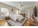 Staged main bedroom featuring a ceiling fan, area rug, and ensuite bathroom at 1272 Saxony Se Dr, Conyers, GA 30013