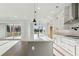 Bright, open kitchen featuring a center island with modern pendant lighting and stainless steel appliances at 2019 Fern Mountain Ln, Marietta, GA 30064