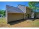Back exterior view of house showcasing siding, dark roof, and a small patio at 2386 Mills Bnd, Decatur, GA 30034