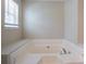 Large soaking tub features neutral tile and modern faucet fixtures at 2386 Mills Bnd, Decatur, GA 30034