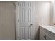 Bathroom with tiled shower with sliding glass door and white cabinets at 2386 Mills Bnd, Decatur, GA 30034