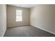 Cozy bedroom features soft carpeting and neutral walls with a window for natural light at 2386 Mills Bnd, Decatur, GA 30034