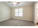 Bright bedroom features neutral walls, carpet, and ceiling fan with light, great natural light from the window at 2386 Mills Bnd, Decatur, GA 30034