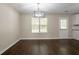 Bright dining room featuring hardwood floors, modern light fixture, and natural light from window at 2386 Mills Bnd, Decatur, GA 30034