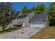 Two-story home with a driveway leading to an attached garage and neutral siding at 2386 Mills Bnd, Decatur, GA 30034