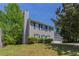 Home featuring a brick chimney, neutral siding, and well-manicured landscaping at 2386 Mills Bnd, Decatur, GA 30034