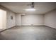 Empty attached garage featuring concrete floor, access door and overhead lighting at 2386 Mills Bnd, Decatur, GA 30034