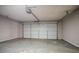 Empty attached garage featuring overhead door and concrete floor at 2386 Mills Bnd, Decatur, GA 30034