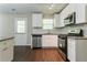 Updated kitchen boasts modern stainless steel appliances, granite counters, and ample cabinet space at 2386 Mills Bnd, Decatur, GA 30034