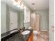 Bathroom featuring a dual sink vanity with black granite countertop and separate shower at 4715 Hill Rd, Powder Springs, GA 30127