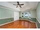 Large bedroom features hardwood floors, a ceiling fan, and many windows at 4715 Hill Rd, Powder Springs, GA 30127