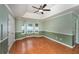 A spacious bedroom features a tray ceiling, ceiling fan, and bay window at 4715 Hill Rd, Powder Springs, GA 30127