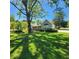 Charming home with beautiful landscaping, mature trees, and a welcoming front porch at 4715 Hill Rd, Powder Springs, GA 30127