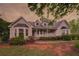 Charming two-story home with a well-maintained lawn and welcoming front porch at 4715 Hill Rd, Powder Springs, GA 30127