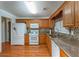 A modern kitchen features granite countertops, stainless steel appliances, and hardwood floors at 4715 Hill Rd, Powder Springs, GA 30127