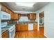 A well-equipped kitchen offers granite countertops, wood cabinets and hardwood floors at 4715 Hill Rd, Powder Springs, GA 30127