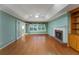 A spacious living room features hardwood floors, a fireplace, built-in shelves, and natural light at 4715 Hill Rd, Powder Springs, GA 30127