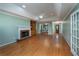 A spacious living room features hardwood floors, tray ceilings, a fireplace, and natural light at 4715 Hill Rd, Powder Springs, GA 30127