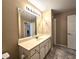 Bathroom with a wide mirror above a white vanity cabinet at 102 Silver Summit Se Dr, Conyers, GA 30094