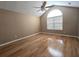 Bright bedroom with hardwood floors, ceiling fan, vaulted ceiling, and a arched window at 102 Silver Summit Se Dr, Conyers, GA 30094