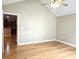 Bright bedroom with hardwood floors, ceiling fan, and view to kitchen at 102 Silver Summit Se Dr, Conyers, GA 30094
