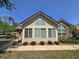 Bright exterior featuring a large window array, an arched window, and manicured landscaping at 102 Silver Summit Se Dr, Conyers, GA 30094