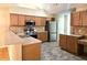 Well-lit kitchen featuring stainless steel appliances, light wood cabinets, and complementary countertop backsplash at 102 Silver Summit Se Dr, Conyers, GA 30094