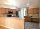 Well-lit kitchen featuring stainless steel appliances, light wood cabinets, and complementary countertop backsplash at 102 Silver Summit Se Dr, Conyers, GA 30094