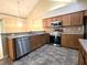Well-lit kitchen featuring stainless steel appliances, light wood cabinets, and complementary countertop backsplash at 102 Silver Summit Se Dr, Conyers, GA 30094