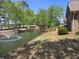 Scenic view of a pond with a fountain surrounded by mature trees and landscaping at 102 Silver Summit Se Dr, Conyers, GA 30094