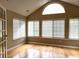 Bright sunroom with large windows, vaulted ceilings, and hardwood floors at 102 Silver Summit Se Dr, Conyers, GA 30094