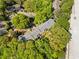 Overhead shot showing an apartment home embraced by vibrant green trees, alongside parking at 1234 Weatherstone Ne Dr, Atlanta, GA 30324