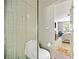 Modern bathroom showcasing a glass-enclosed shower and toilet, leading to a bedroom with ample natural light at 1234 Weatherstone Ne Dr, Atlanta, GA 30324