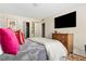 Comfortable bedroom with plush pillows, a television, and ample storage, providing a relaxing retreat at 1234 Weatherstone Ne Dr, Atlanta, GA 30324